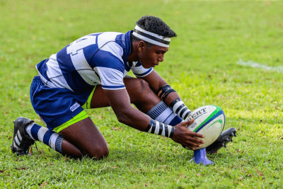 Rugby is a full-contact sport played with an oval-shaped ball. Two teams of 15 players each aim to score points by carrying, passing, and kicking the ball over the opponent's goal line.